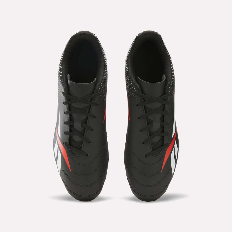 A pair of Reebok Strike Multi Ground Soccer Cleats with a synthetic upper in black, featuring white and red accents, viewed from above on a plain white background.