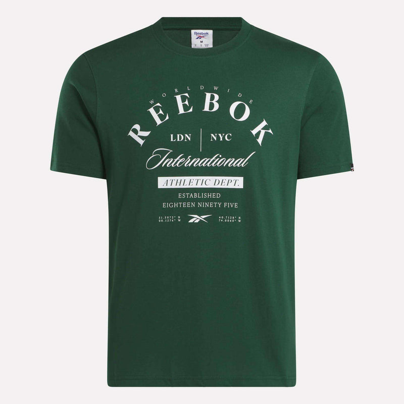 The Reebok Men's International Graphic T-Shirt features a green cotton design with bold white text and logo, offering comfortable style for a casual look.