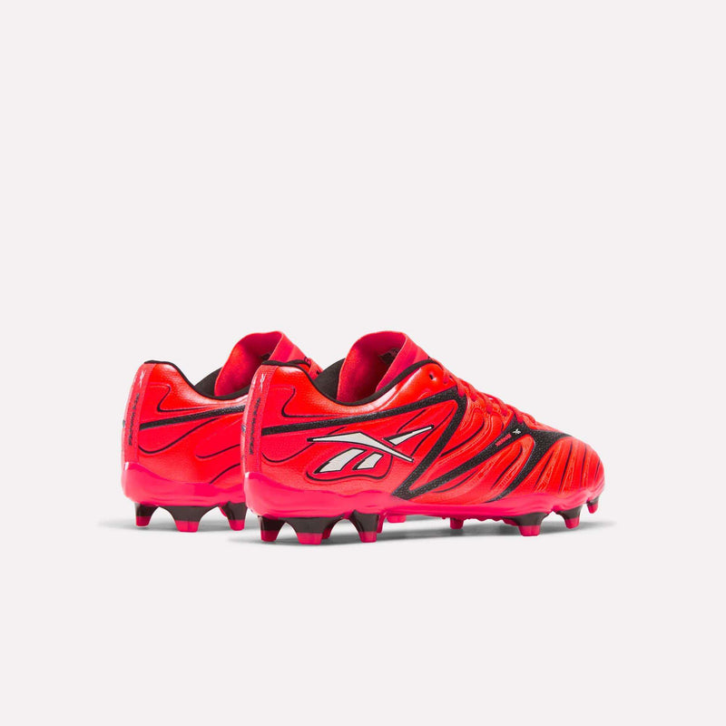The Reebok Sidewinder 26 League Firm Ground Cleats for big kids are displayed against a plain white background. These bright red soccer shoes feature black and white accents, a bold sporty design, and molded studs ideal for firm ground play.