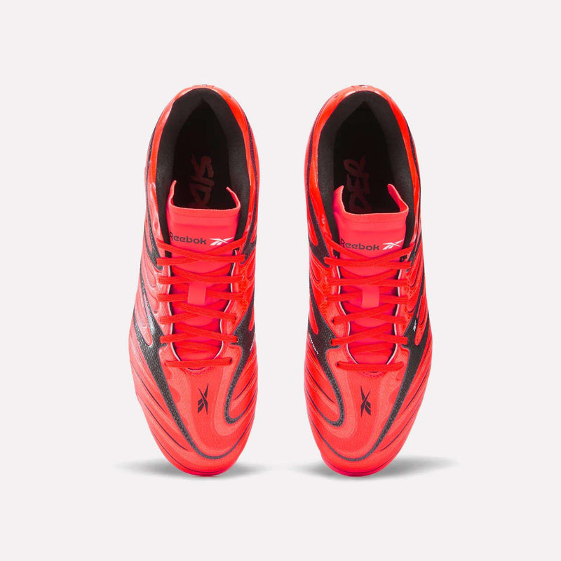 Top view of a pair of Reebok Sidewinder 26 League Firm Ground Cleats for big kids in bright red with black accents and laces, displayed side by side on a plain white background, featuring classic soccer-inspired firm ground studs.