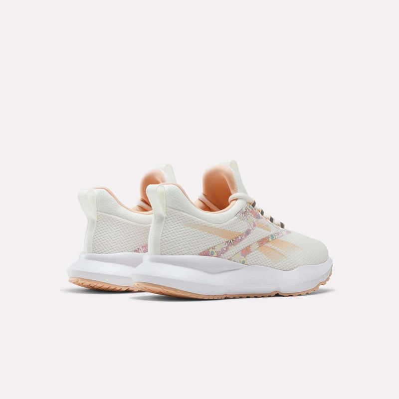 A pair of Reebok Women's Cityride 2 Running Shoes in white with peach and floral accents, featuring FuelFoam cushioning, displayed from the back and side on a plain light background.