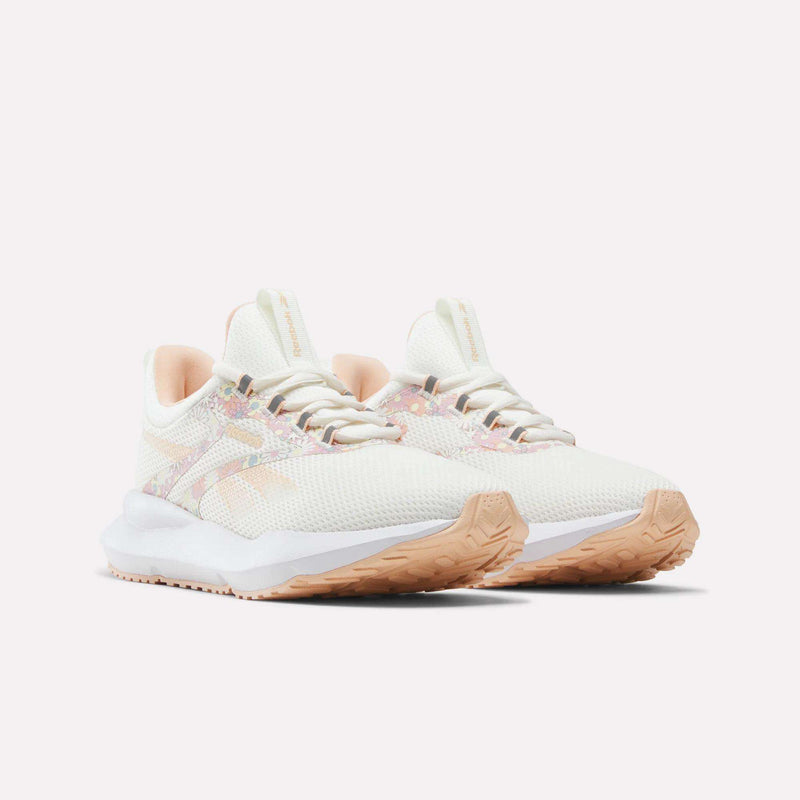 A pair of Reebok Women's Cityride 2 Running Shoes in white, featuring light pink and peach accents, a textured mesh upper, FuelFoam cushioning for enhanced comfort, and tan rubber soles, displayed on a plain white background.