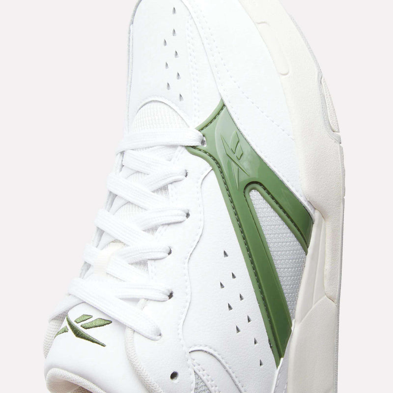 Close-up of the Reebok Omni Edge Shoes, a white sneaker with green accents. The design features a leather upper, white laces, perforated details, and a green Reebok logo on the side. The shoe is angled to highlight both the side and top, evoking the classic aesthetic of retro basketball footwear.