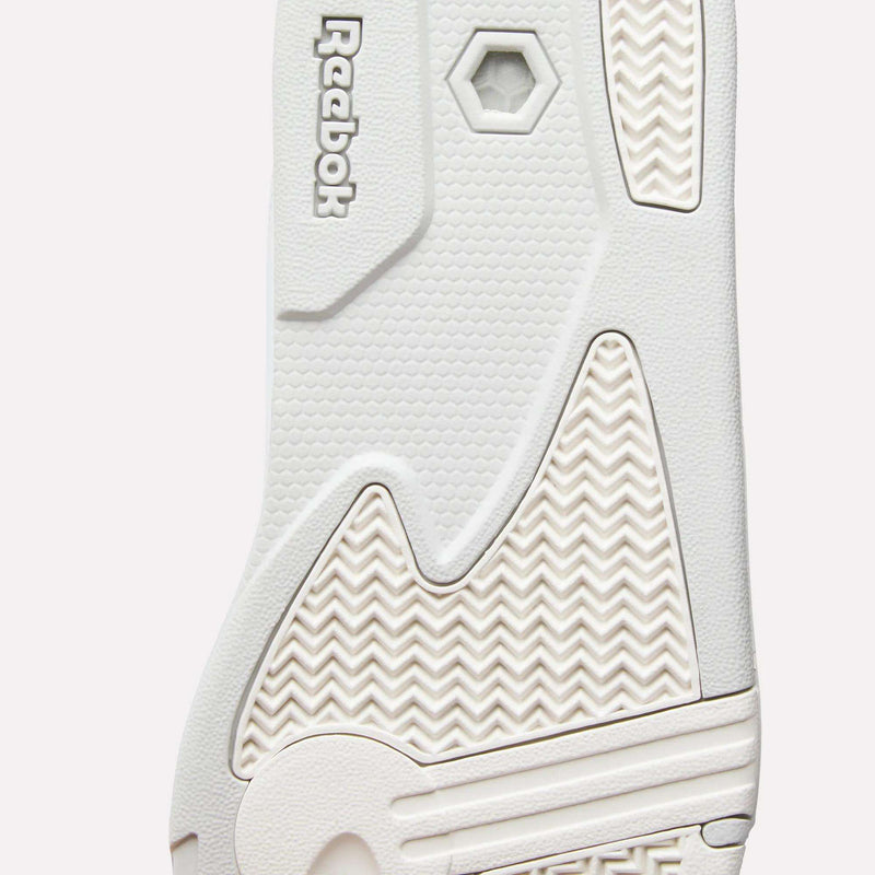 Close-up of the sole of the Reebok Omni Edge Shoes in white, highlighting its textured patterns, hexagonal-shaped grip, and the Reebok logo embossed near the top—showcasing the classic features that distinguish these retro basketball sneakers.