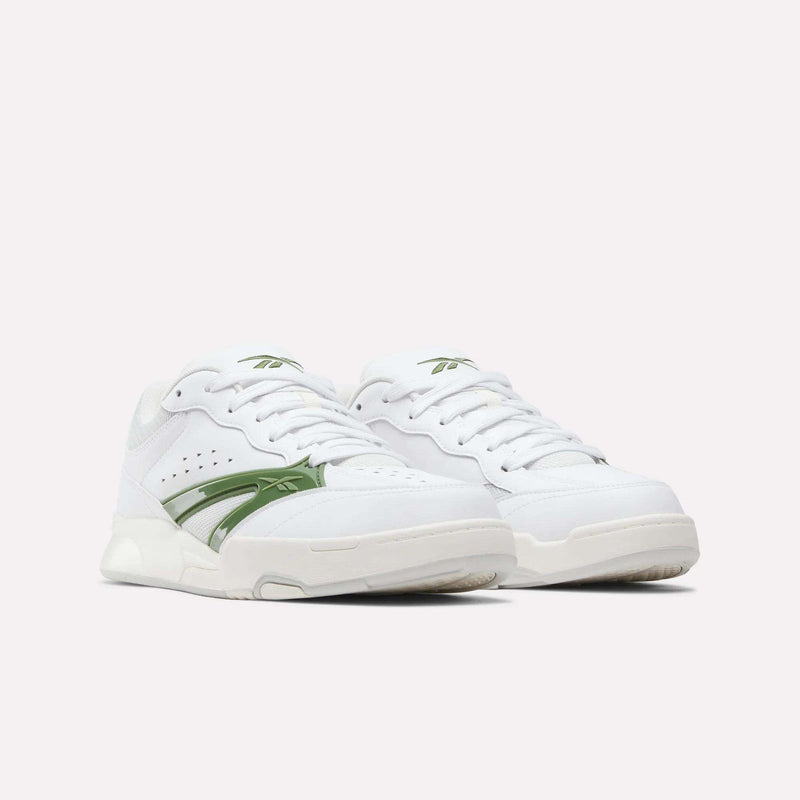 A pair of white Reebok Omni Edge Shoes featuring green accents and logo details on the side and tongue, crafted with a leather upper inspired by retro basketball shoe design, displayed on a white background.