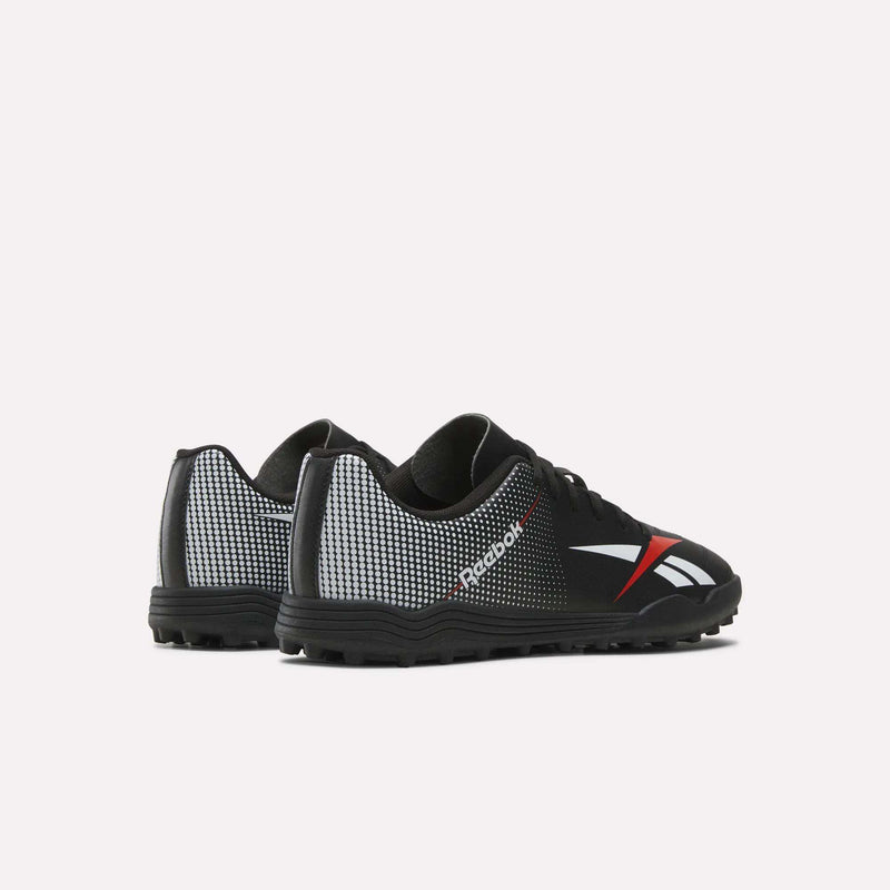 A pair of Reebok Strike Turf Soccer Shoes in black, featuring white and red accents, displayed from the back and side angles against a plain light background—ideal for practice sessions on turf.