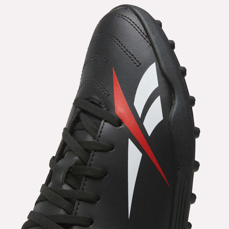 Close-up of the Reebok Strike Turf Soccer Shoes in black, featuring black laces and a distinctive red and white stylized logo on the side. These turf soccer shoes are designed for optimal performance on both turf and grass fields.