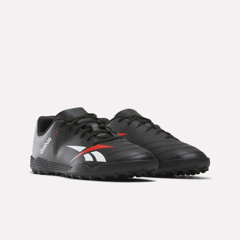 The Reebok Strike Turf Soccer Shoes are a pair of black athletic footwear accented with white and red details, featuring textured soles and the Reebok logo on the side, displayed against a plain white background.