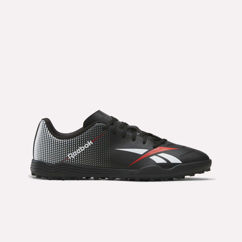 The Reebok Strike Turf Soccer Shoes in Black/Red feature white and red accents, a dotted pattern on the heel, and a white Reebok logo on the side. Shown against a plain white background, these stylish soccer shoes deliver both performance and flair—ideal for practice or playing on turf.