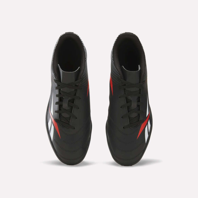 A top-down view of Reebok Strike Turf Soccer Shoes in black with red and white accents, set against a clean white background.