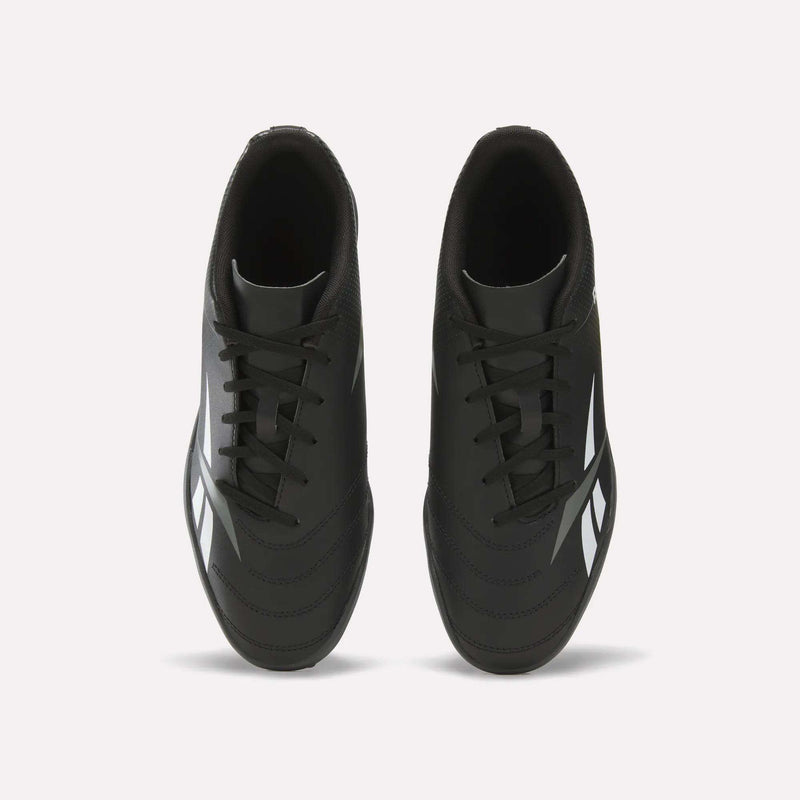 Top view of a pair of Reebok Strike Turf Soccer Shoes in black with white accents and black laces, placed side by side on a plain white background—perfect for soccer practice.