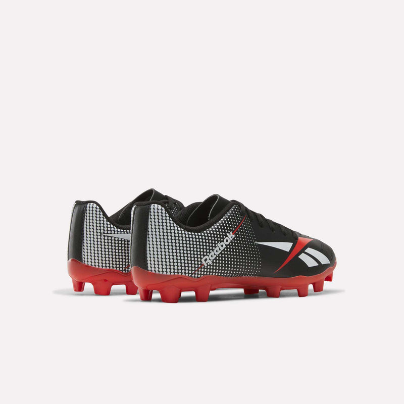 A pair of black Reebok Strike Multi-Ground Soccer Shoes - Big Kids with red soles and white accents, displayed on a white background.