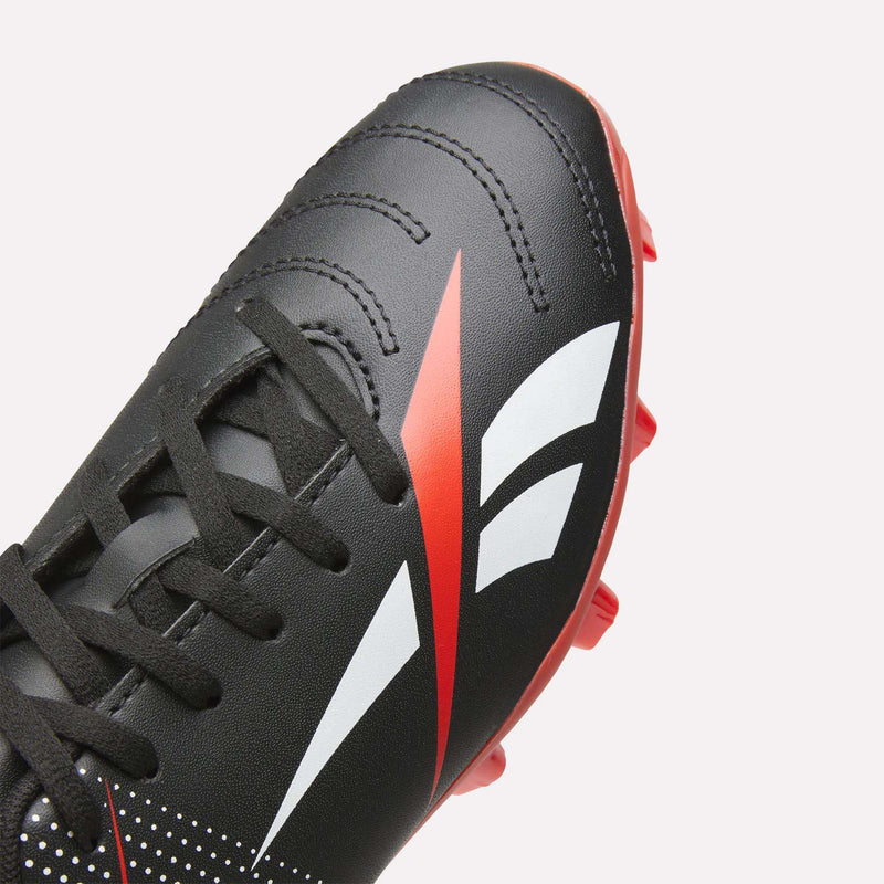 Close-up of black Reebok Strike Multi-Ground Soccer Shoes - Big Kids with red and white graphics, black laces, and red studs—perfect for turf—on a light background.