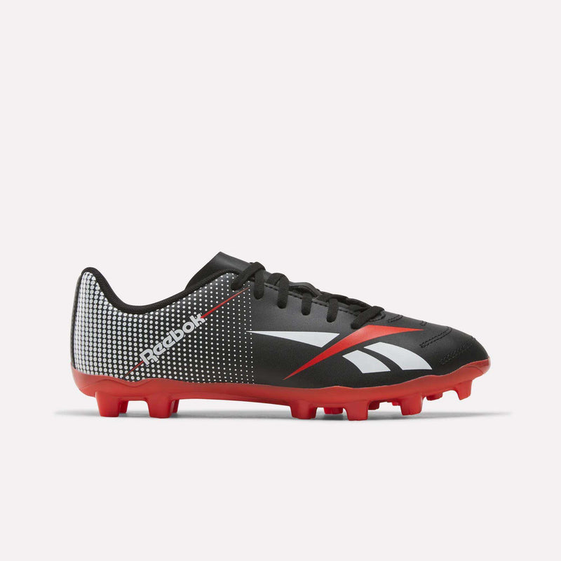 Strike Multi-Ground Soccer Shoes - Big Kids by Reebok in Black/Red, featuring molded red turf studs, white logo, black laces, and white/red accents, displayed on a plain white background.