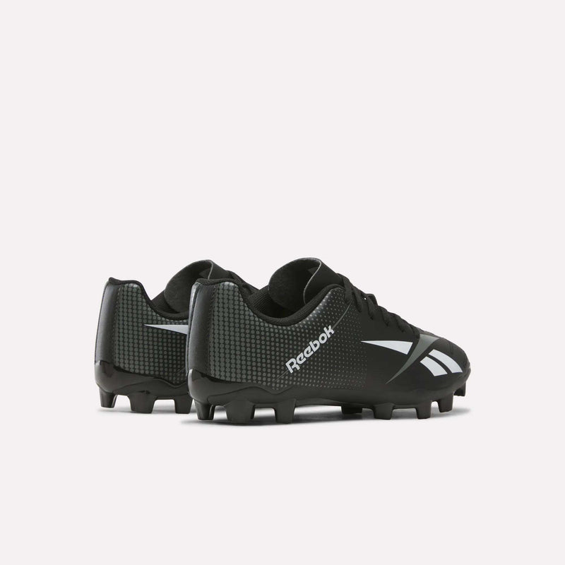 A pair of Reebok Strike Multi-Ground Soccer Shoes for big kids in black, featuring white logos and textured heel panels, designed for turf play, shown on a plain white background.