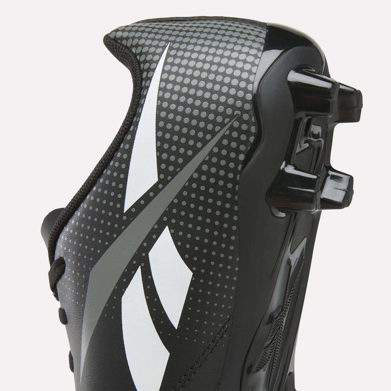 Close-up of the Reebok Strike Multi-Ground Soccer Shoes for big kids in black, highlighted with white and gray accents, featuring small dotted patterns and plastic cleats on the outsole for enhanced grip and turf performance.