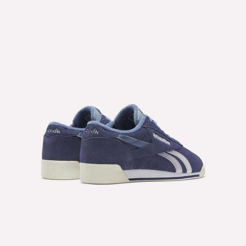 Women’s Freestyle Lo Shoes by Reebok in dark blue suede and leather with white side stripes and off-white soles.