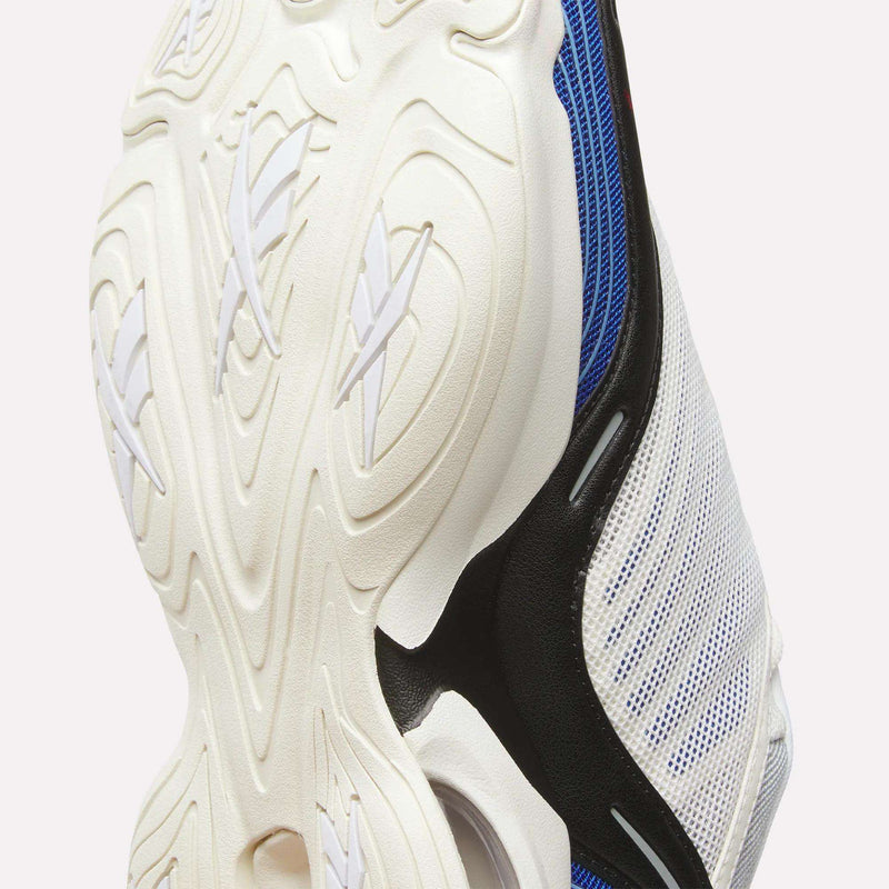 Close-up of the DMX Series 3000 Shoes by Reebok, featuring a white, textured rubber outsole with wavy patterns and cross-shaped grooves. Sections of blue and black mesh upper are visible along the side—emphasizing the shoe’s advanced DMX moving air technology for superior cushioning.