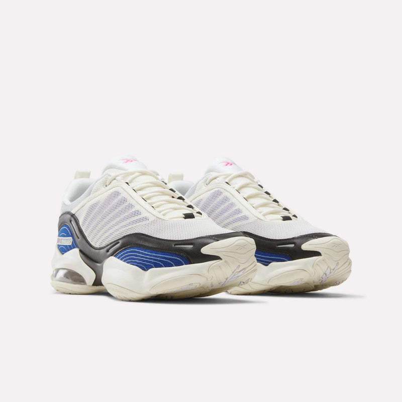 A pair of Reebok DMX Series 3000 Shoes with white mesh uppers, cream soles, black and blue accents, and pink logo details—featuring DMX moving air technology for enhanced comfort—displayed against a plain white background.