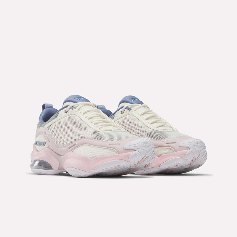 The Reebok Women's DMX Series 3000 Training Shoes feature white mesh uppers with light pink and beige accents, blue details on the tongue and heel, chunky white soles with visible air cushioning, and advanced DMX 3 Technology—offering cushioned comfort and support for a superior walking experience.