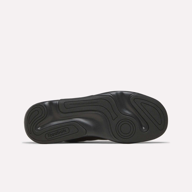 The Reebok DMX Comfort+ Classic walking shoe’s black sole, shown from the bottom against a plain white background, displays swirling tread patterns and textured grip zones, enhanced with dynamic air cushioning for exceptional comfort.
