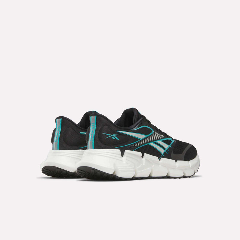 A pair of Reebok Men's FloatZig 2 Running Shoes in black with teal accents and white chunky soles, featuring Superfloat+ cushioning, shown from the back and side on a plain light background.