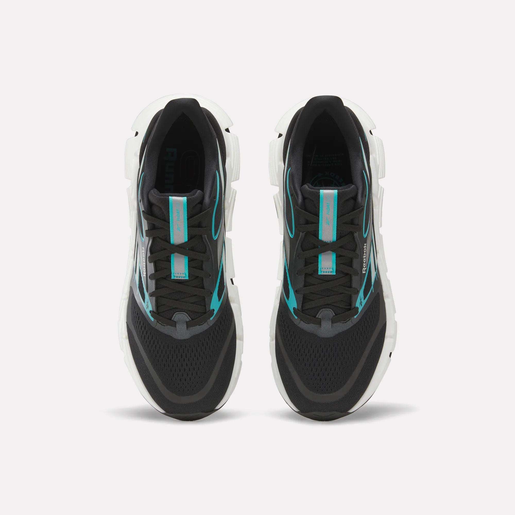 A pair of Men's FloatZig 2 Running Shoes by Reebok, black with white soles and turquoise accents, featuring Superfloat+ cushioning, shown side by side from above on a plain white background.
