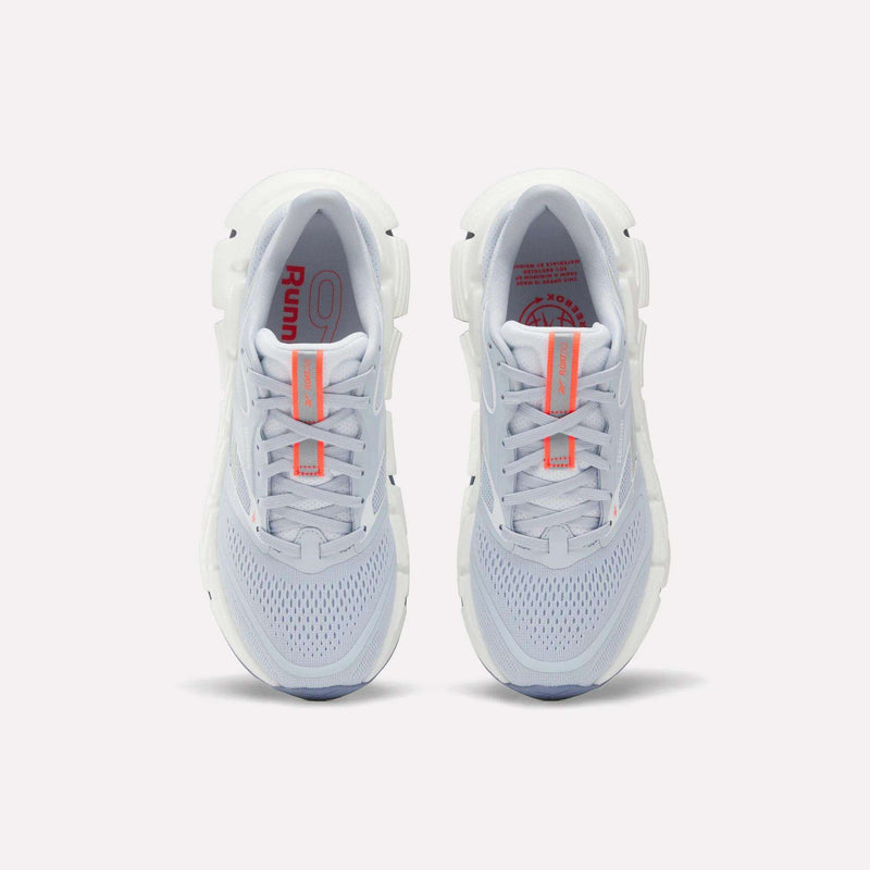 Top view of Reebok Women's FloatZig 2 Running Shoes with light gray mesh uppers, Superfloat+ cushioning for a springy feel, white soles, and orange accents on the tongue and insole, placed side by side on a plain background.