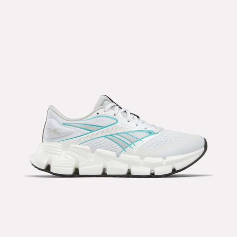 The Reebok Women's FloatZig 2 Running Shoes in White/Grey/White feature Superfloat+ cushioning, a segmented sole, and black outsole, shown in side profile on a plain white background.