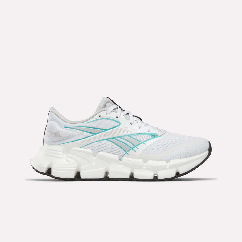The Reebok Women's FloatZig 2 Running Shoes in White/Grey/White feature Superfloat+ cushioning, a segmented sole, and black outsole, shown in side profile on a plain white background.