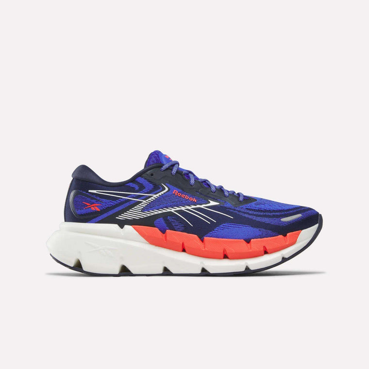 The Men's FloatZig Double Running Shoes by Reebok in Blue/Blue/White feature StableStack construction for max cushioning and a thick white sole, shown on a plain light background.