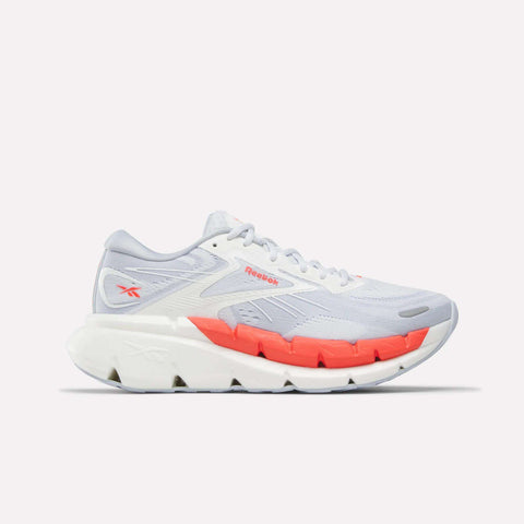 The Reebok Women's FloatZig Double Running Shoes in White/Grey/Red feature a modern, sporty design with breathable mesh, cushioned support, and bold red accents on the midsole and logo for stable comfort over long distances.