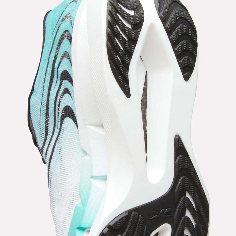 Close-up of the sole of a Reebok SpeedShifter Running Shoe in white and aqua, featuring black wavy tread patterns and textured grip that showcase the outsole design, HyperFloat foam cushioning, and advanced comfort.