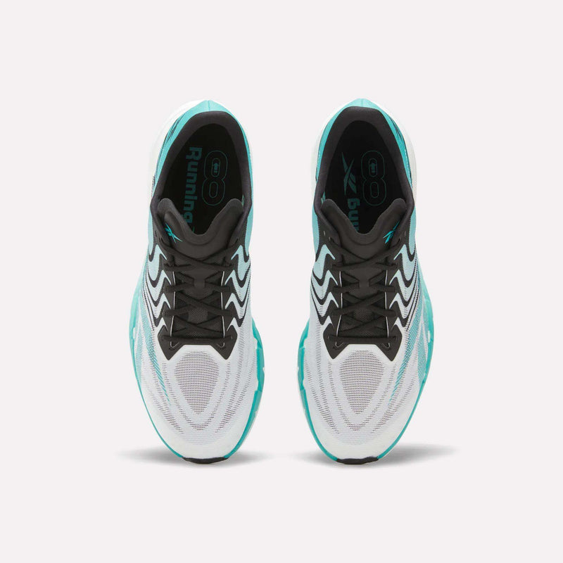 Top view of a pair of Reebok SpeedShifter Running Shoes in white, with black laces and teal accents, featuring HyperFloat foam cushioning, placed side by side on a light background.