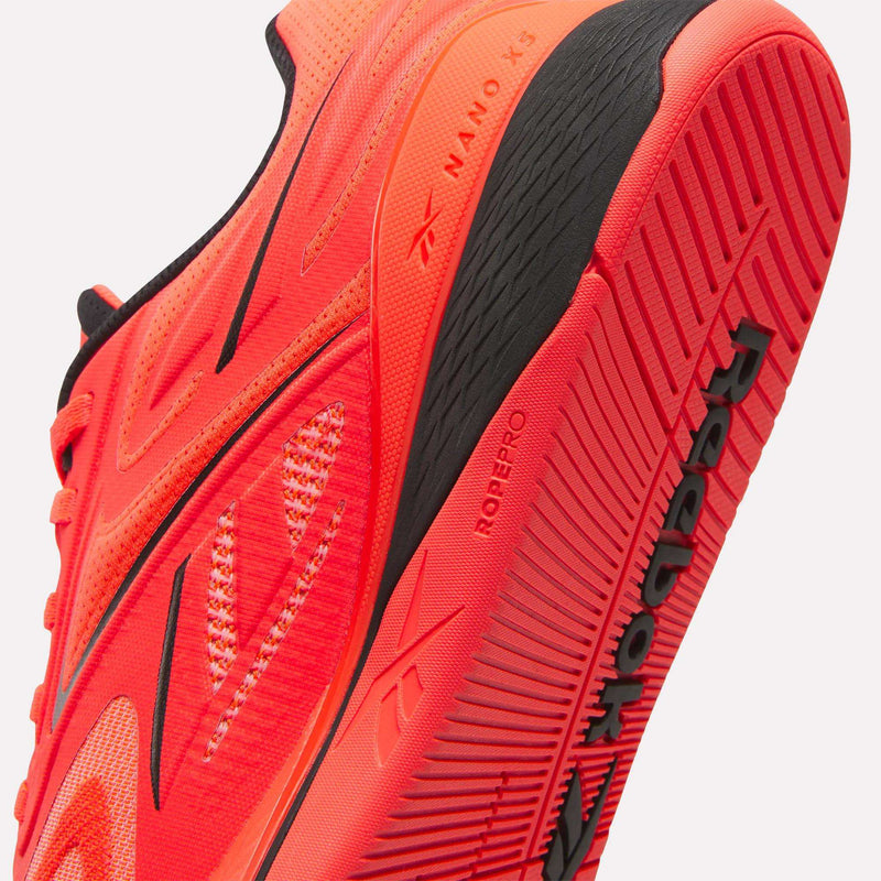 Close-up of a vibrant red Reebok Nano X5 Edge Training Shoe highlighting the textured sole, Reebok branding, and Nano X5 Edge detailing—showcasing the shoe’s intricate design and premium materials, ideal for athletes seeking high-performance training footwear.