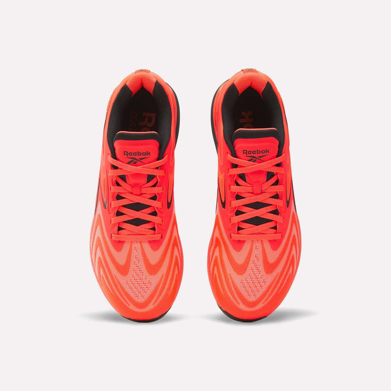 Top view of Reebok Nano X5 Edge Training Shoes in bright orange with black accents and wavy patterns, featuring laces and logo on the tongues, designed for peak performance on a white background.