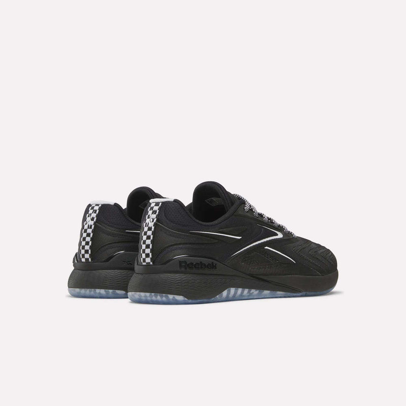 A pair of Women's Nano X5 Edge Training Shoes by Reebok in black with silver accents, a wavy side design, and a black-and-white checkered heel, shown from a rear-side angle on a plain white background.