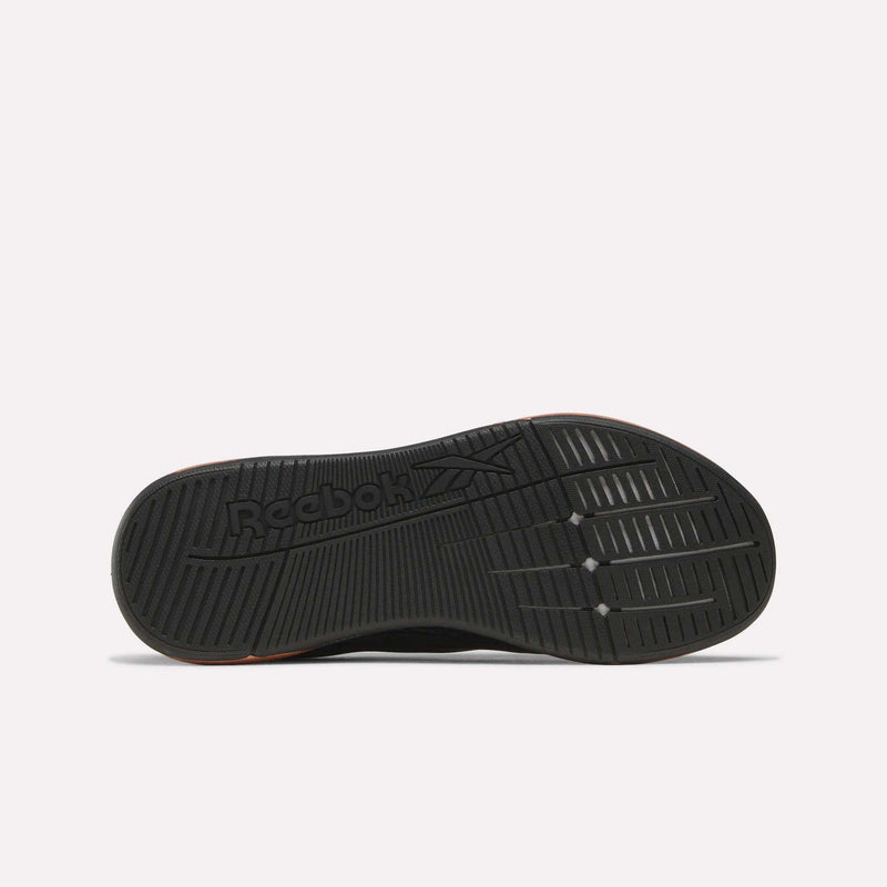 The image displays the black rubber outsole of Reebok Women's Nano X5 Edge Training Shoes, featuring grooved traction patterns and the Reebok logo. The shoe is shown sole-up on a plain white background—ideal for HIIT class.
