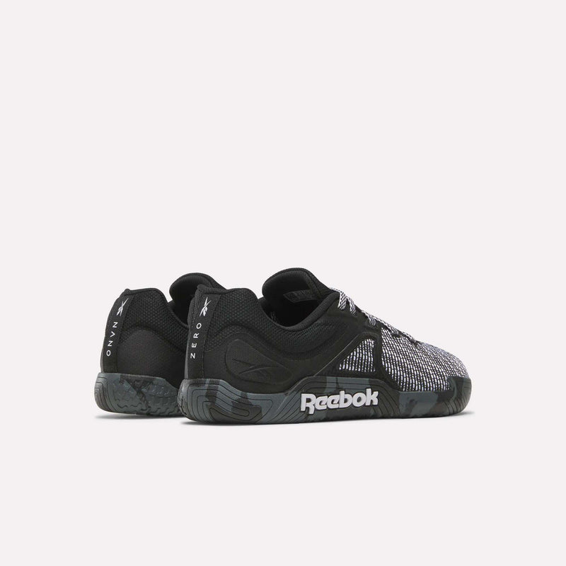 A pair of black and gray Reebok Nano Zero Training Shoes with textured soles and mesh details, ideal for strength training. Viewed from the side and slightly angled to the back. The Reebok logo is visible on the sole and heel.