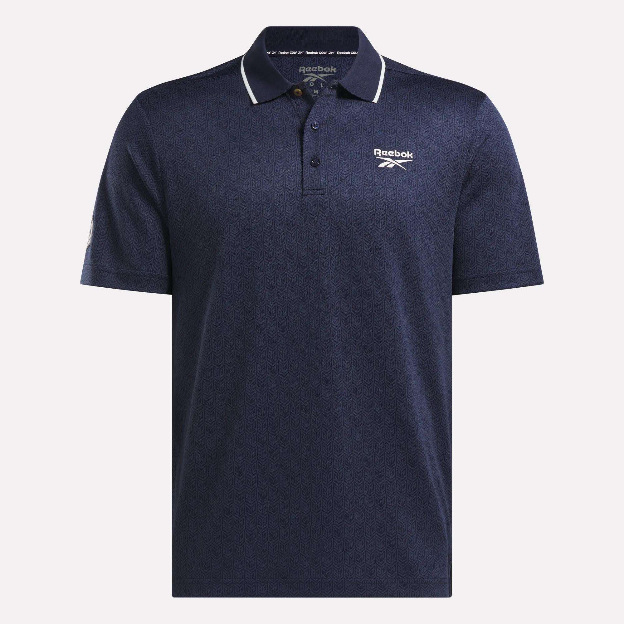 The Men's BDC Signature Polo Shirt by Reebok is navy blue with a subtle pattern, white piping on the collar, and Reebok logos. Made from RBK-DRY fabric, it features a three-button placket and short sleeves for cool comfort.