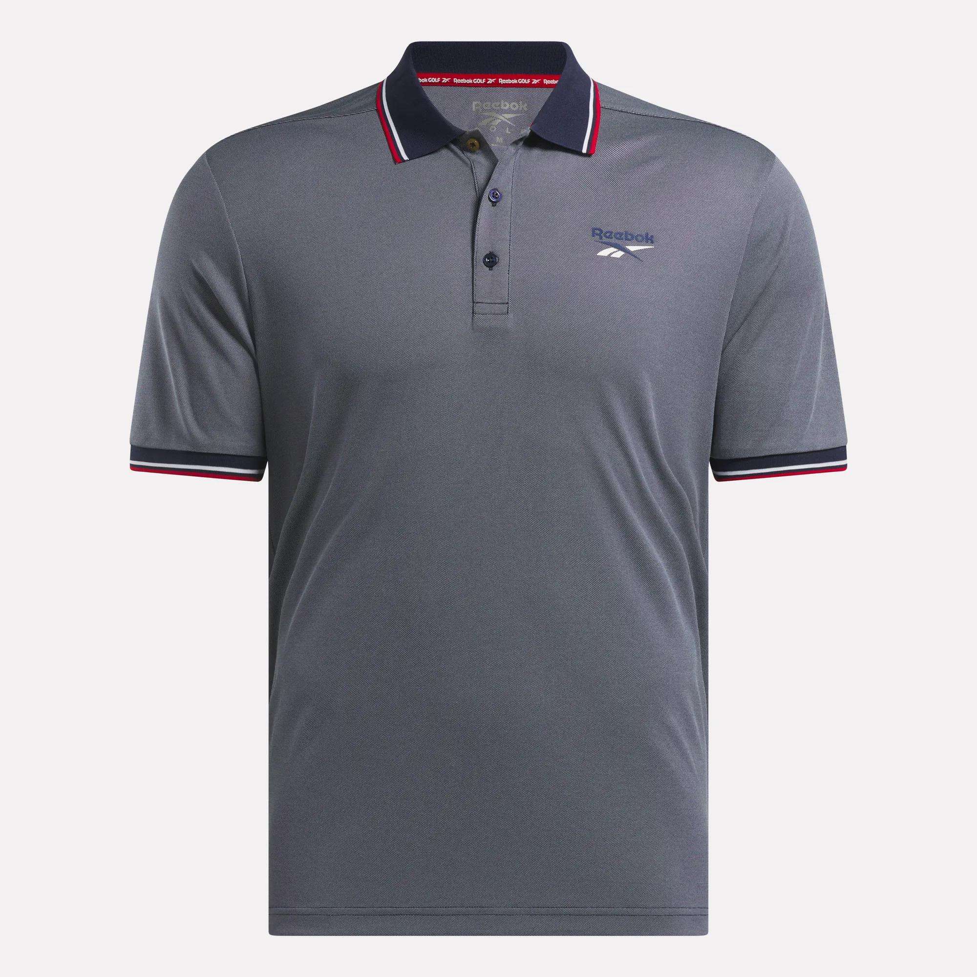 The Reebok Men's Country Club Oxford Pique Polo Shirt is a grey, short-sleeve golf polo featuring a collar, three-button placket, red/white/black trim on the collar and sleeves, and the Reebok logo on the left chest.