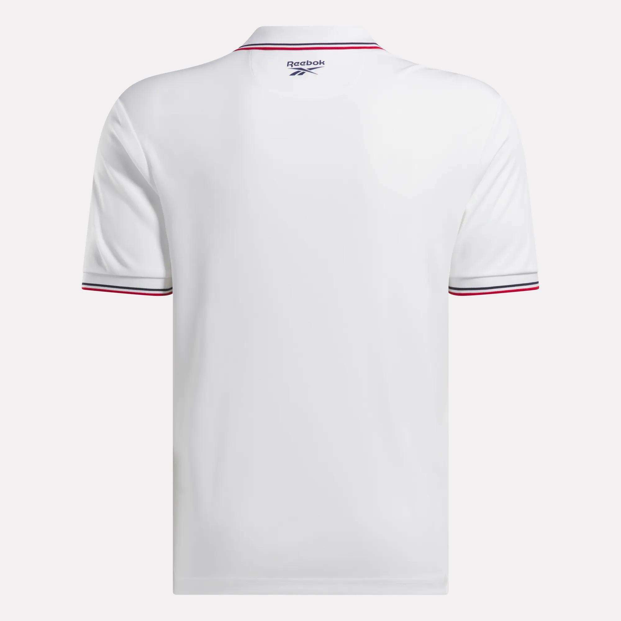 The Reebok Men's Country Club Oxford Pique Polo Shirt in white is shown from the back, featuring thin red and black stripes on the sleeve cuffs and a small Reebok logo near the collar for a stylish, sporty accent.