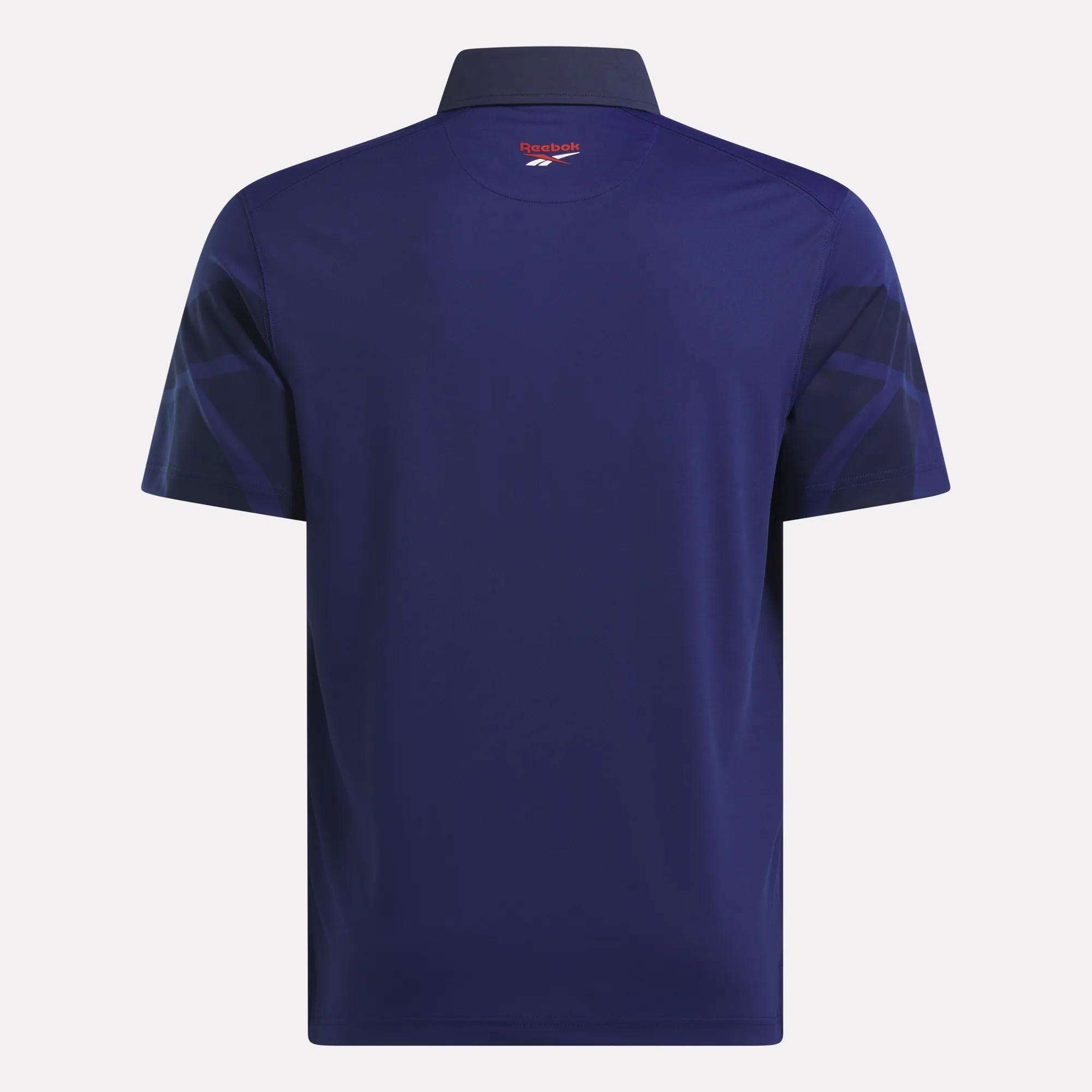 The Reebok Men’s Signature Vector Colorblocked Polo Shirt is shown from the back in navy, with a collar, subtle dark sleeve patterns, and the Reebok logo near the collar. Moisture-wicking fabric keeps you cool and comfortable.