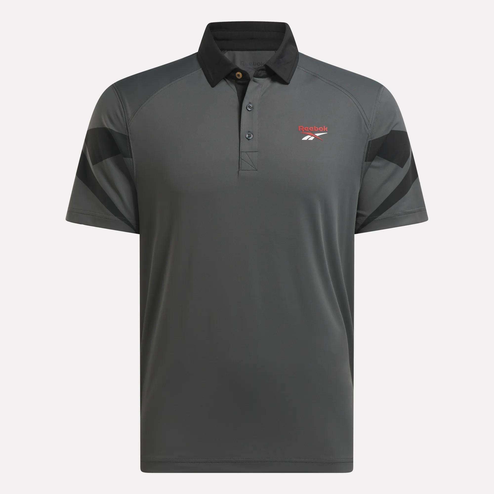 The Reebok Men's Signature Vector Colorblocked Polo Shirt is gray with short sleeves, a black collar, black shoulder accents, and a red logo on the chest. Crafted with RBK-DRY fabric for cool, comfortable wear on the golf course.