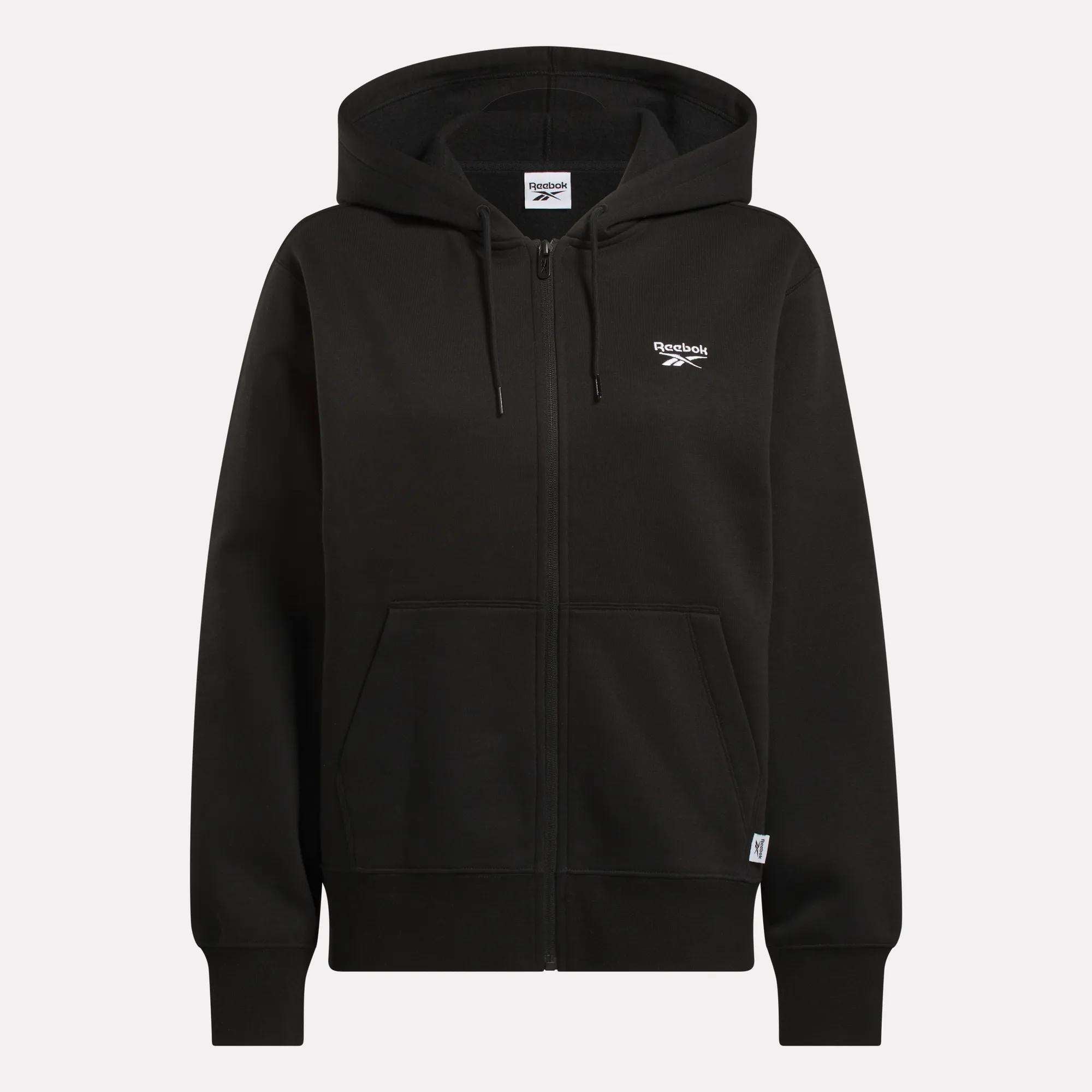 The Reebok Women's Small Vector Full Zip Sweatshirt is a black zip-up hoodie with drawstrings, front pockets, and a white Reebok logo on the left chest, shown against a plain light background.