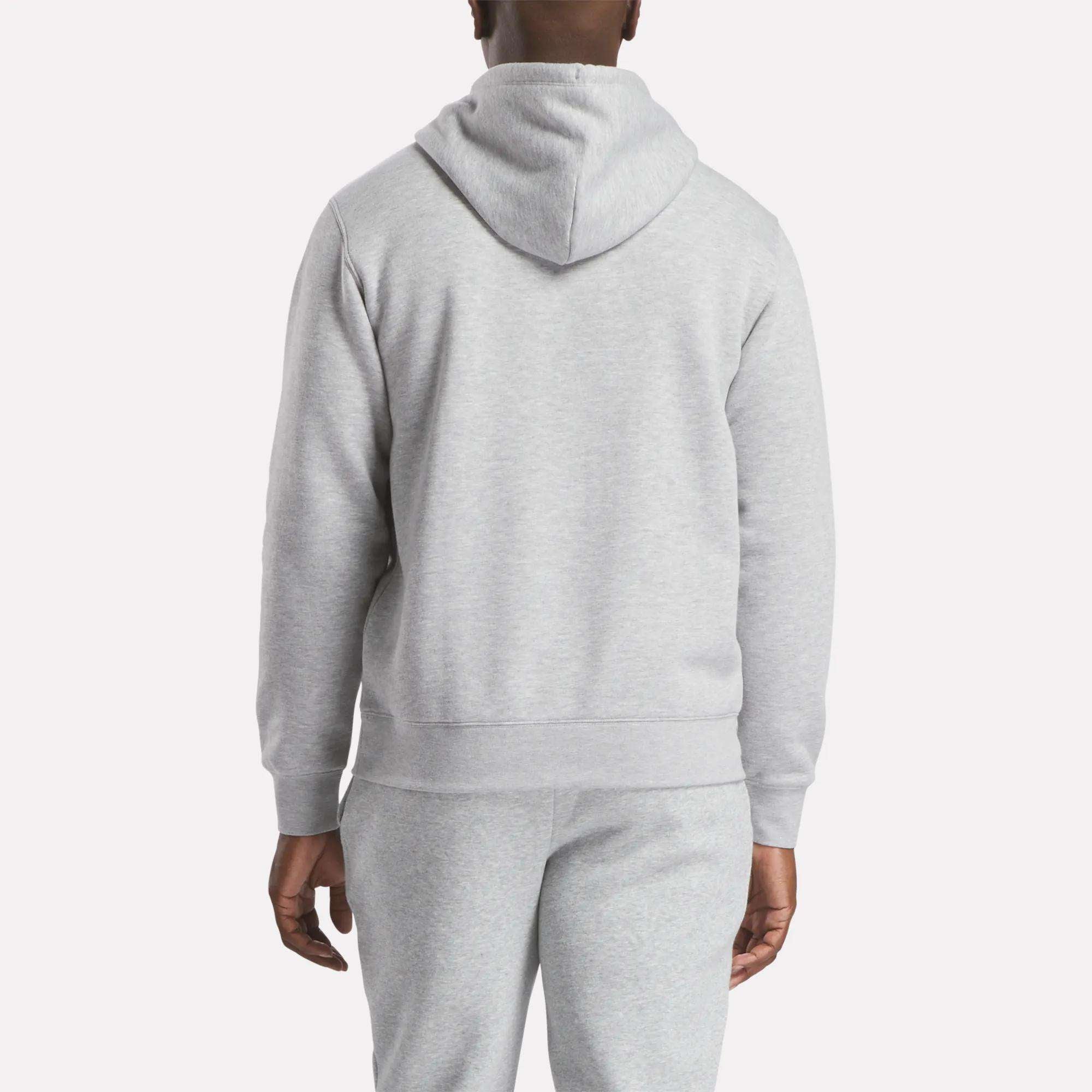 A man is seen from the back wearing the Reebok Men's Finisher Hoodie in light gray, paired with matching sweatpants, standing against a plain white background.
