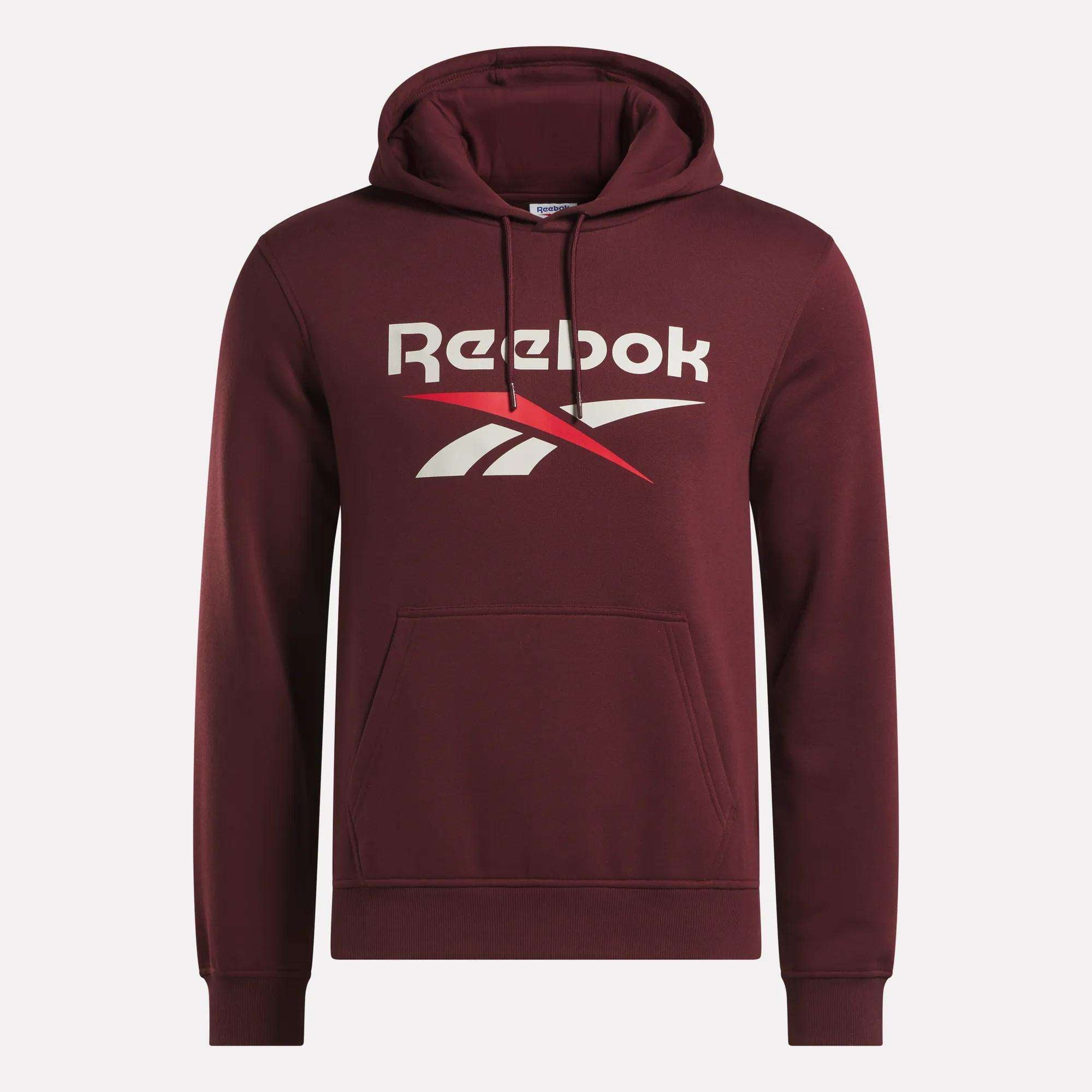 The Men's Logo Hoodie by Reebok is a maroon pullover for men with a front kangaroo pocket, drawstring hood, and bold white and red Reebok logo on the chest, crafted from soft cotton-blend fleece for comfort.