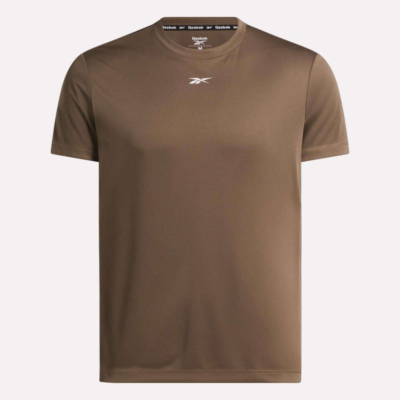 The Men's Short Sleeve Tech Training T-Shirt by Reebok features RBK-DRY fabric, short sleeves, a small white logo on the chest, and branded tape inside the neckline. Shown in brown against a light background, it's ideal for gym workouts.