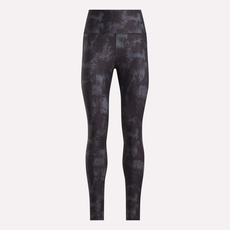 Reebok Women's High-Rise Printed Leggings showcase an abstract dark gray and black design, made from sweat-wicking fabric, shown against a plain light background.