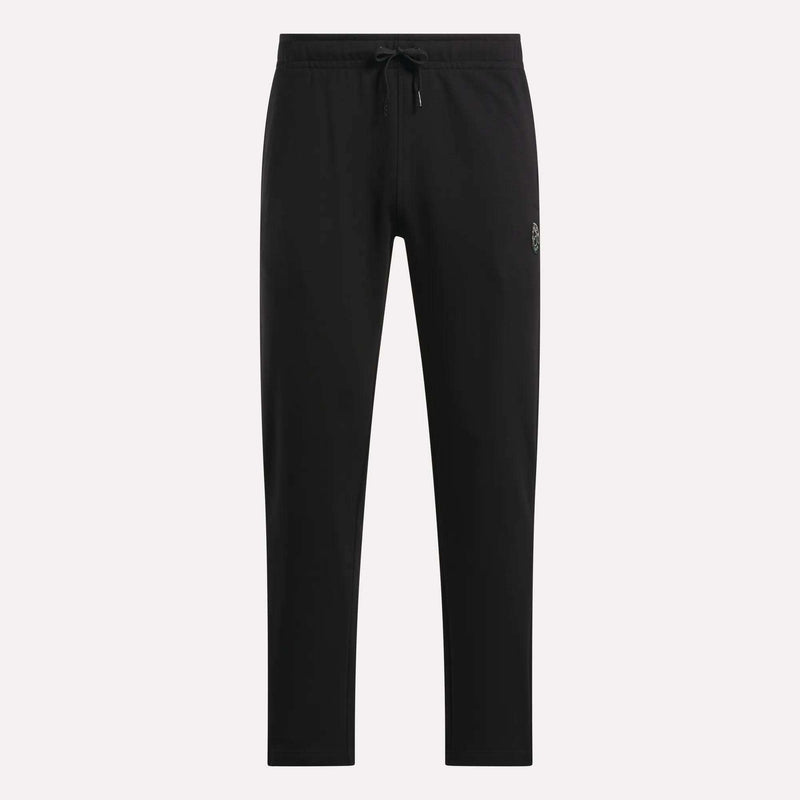 The Men's French Terry Jogger Pants by Reebok feature a slim fit and a soft, comfortable feel. Displayed against a plain white background, these black athletic pants are styled with a small Reebok logo detail on the upper left thigh.